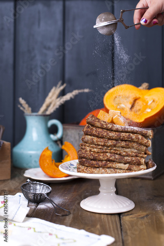 Delicious homemade pancakes for breakfast, with pumpkin and honey. Breakfast for the whole family. Rustic photo. Copy space, © Marina