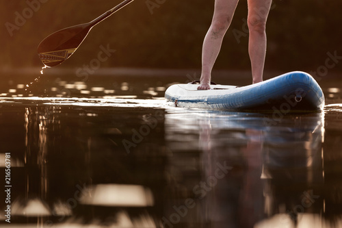 Partial view of stand up paddler at sunset