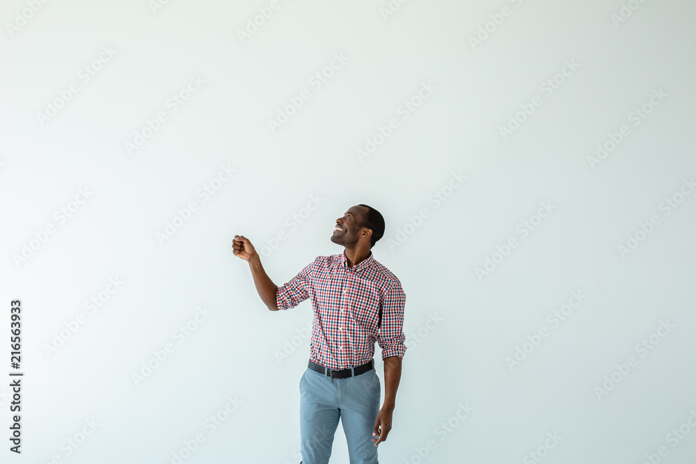 Cheerful afro american man holding an umbrella Cheerful afro american man holding an umbrella