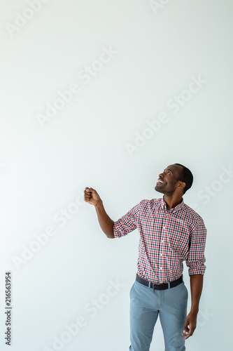 Smilign afro american man walkign with an umbrella photo