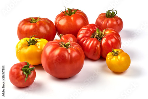 Colorful yellow and red tomatoes of different sizes and kinds isolated on white background © GSDesign