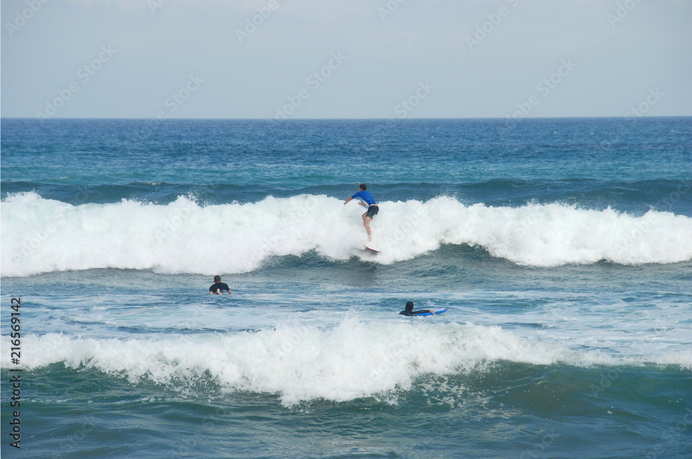 Surfing on sea waves by Pantai Batu Bolong beach of south Bali, Indonesia 