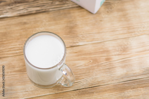 Glass kefir (milk) on a wooden background. The concept of diet, weight loss.