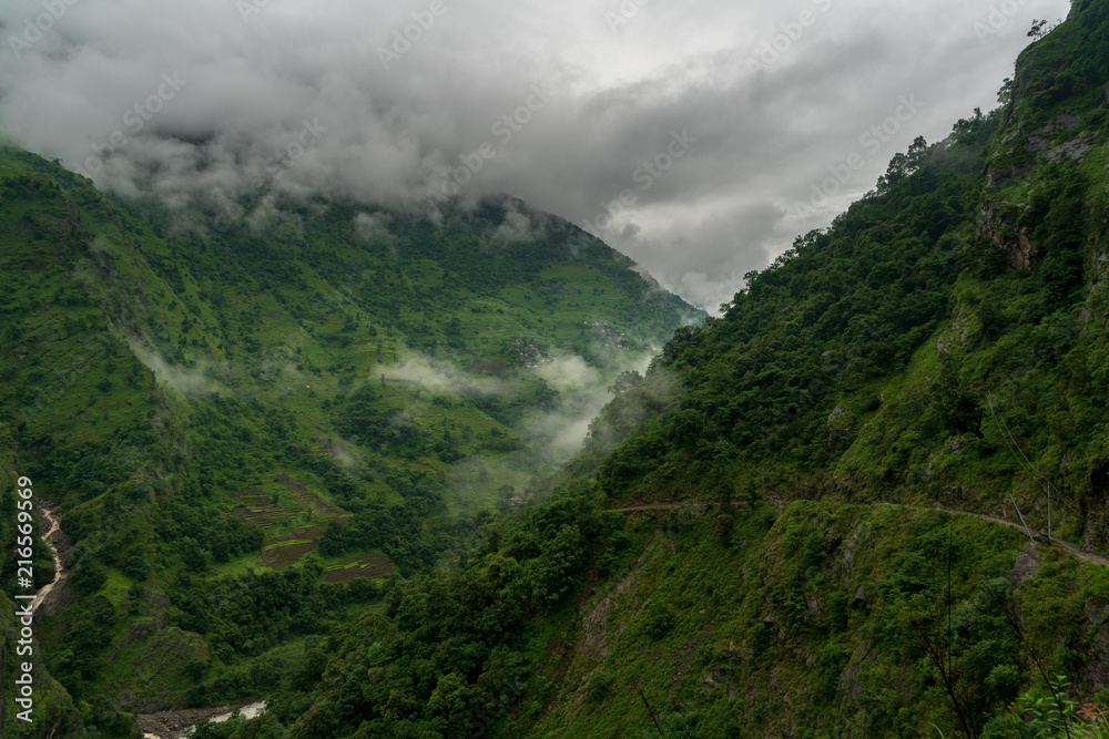 Moody clouds find their way around foothills of the Annapurna Range