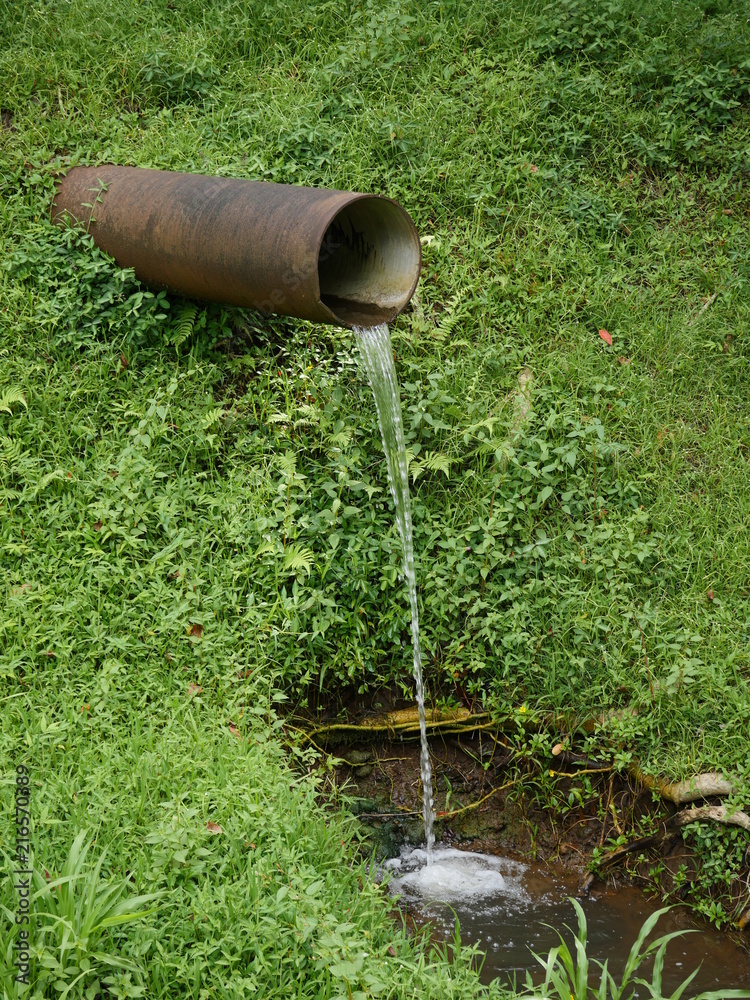 water drained out of a big pipe into nature water drained out of a big pipe into nature