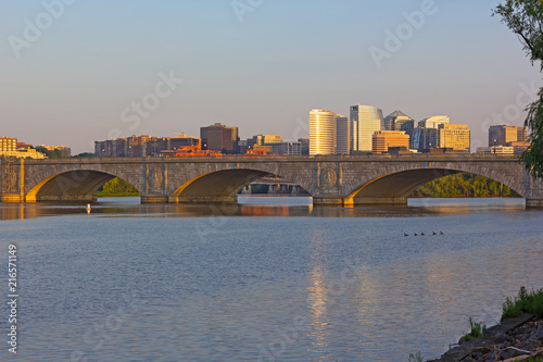 Arlington Memorial Bridge and Rosslyn suburb at sunset, Washington DC, USA. Panoramic view on Potomac River and Washington DC metro area buildings across the river.