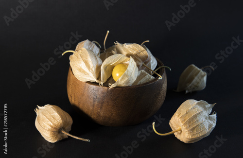 Golden Berries in a bowl on dark background