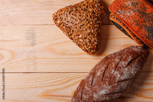 Rye bread and poopy bun on wooden. Homemade traditional bread photo