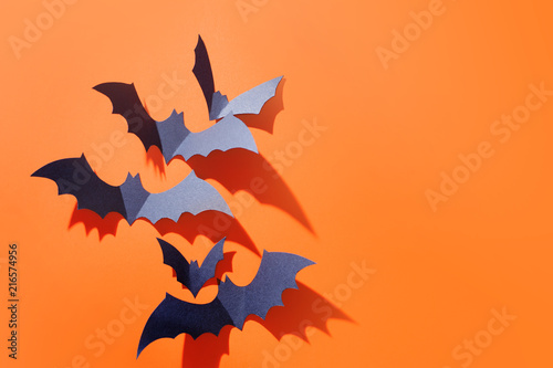 Halloween background. A lot of bats on orange.