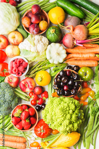 Fototapeta Naklejka Na Ścianę i Meble -  Summer fruits vegetables berries background, apples cherries peaches strawberries cabbage broccoli cauliflower squash tomatoes carrots spring onions beetroot, top view, selective focus