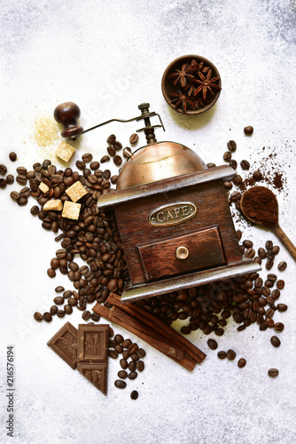 Antique vintage retro wooden coffee grinder on a light slate, stone or concrete background.Top view with copy space.