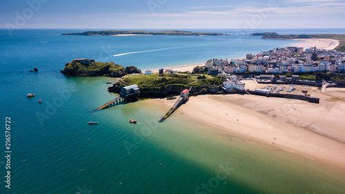 Aerial drone view of a beautiful coast town with sandy beaches and colorful buildings (Tenby, Wales, UK)