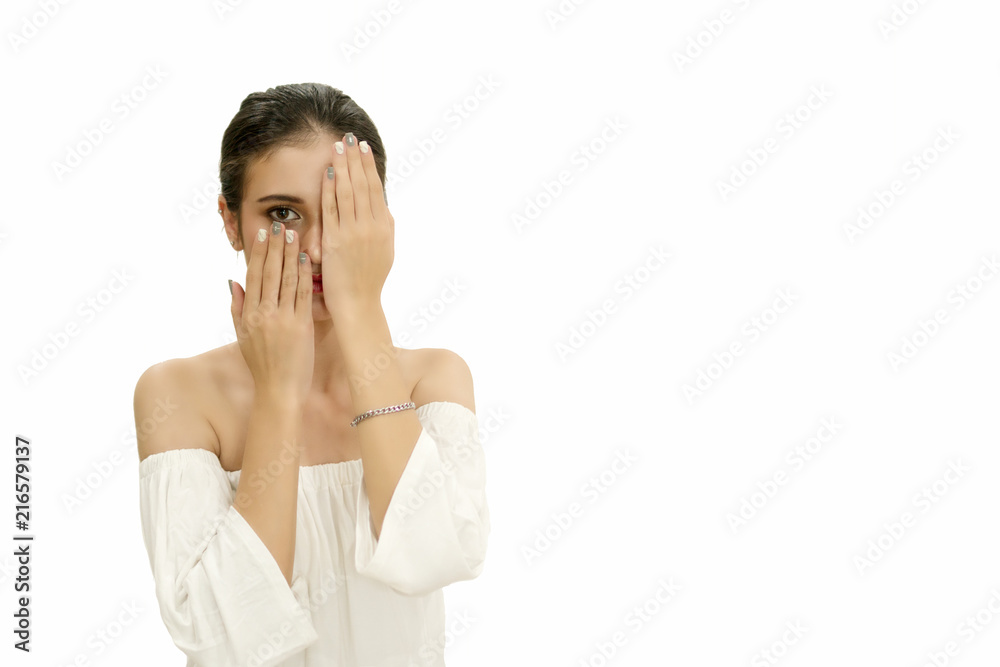 Attractive young woman covering her face with one hands while looking at camera on white background. Attractive young woman covering her face with one hands while looking at camera on white background.