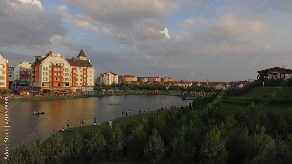 Krasnodar, German village, Russia may 15, 2018 gray helicopter takes off over the lake in a residential area among people. Krasnodar, German village, Russia may 15, 2018 gray helicopter takes off over the lake in a residential area among people.