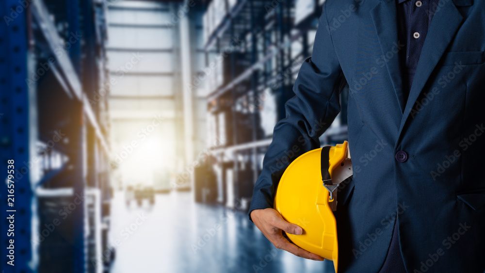 Business Logistics concept, Double exposure of engineer or worker hold yellow helmet for workers security with Modern Trade warehouse logistics Business Logistics concept, Double exposure of engineer or worker hold yellow helmet for workers security with Modern Trade warehouse logistics