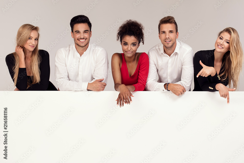 Group of elegant people with empty white board. Group of elegant people with empty white board.