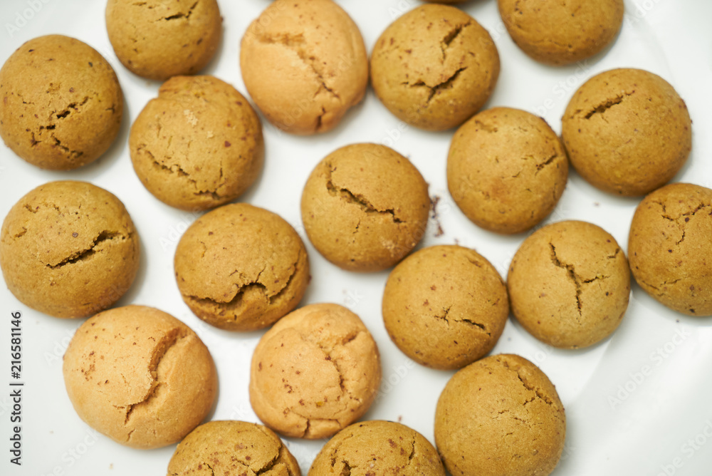 Cookies and sweet biscuits on white plate background, top view 