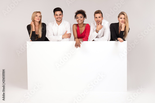 Group of elegant people with empty white board.