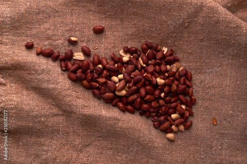 walnut peanut scattered in the form of a continent north america on sackcloth background. Space for text. Copyspace photo