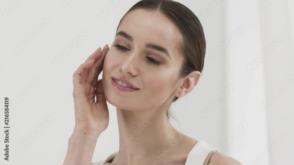 Beauty Care. Attractive Smiling Woman Caressing Face Skin Beauty Care. Attractive Smiling Woman Caressing Face Skin
