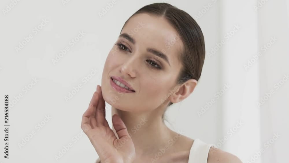 Beauty Care. Attractive Smiling Woman Caressing Face Skin Beauty Care. Attractive Smiling Woman Caressing Face Skin