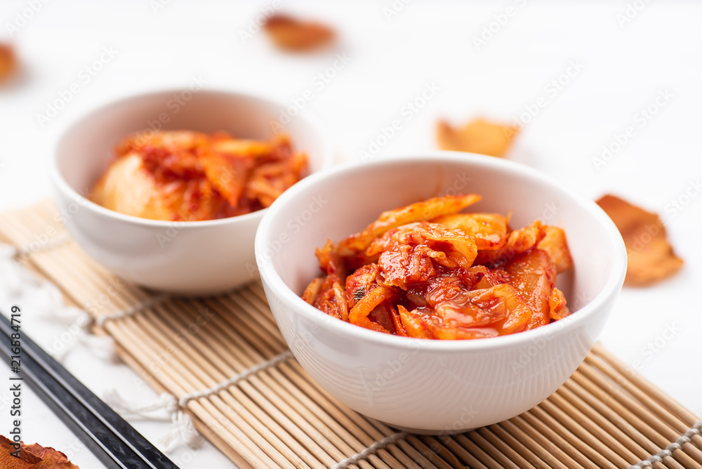 Kimchi cabbage in a bowl with chopsticks, Korean food Kimchi cabbage in a bowl with chopsticks, Korean food