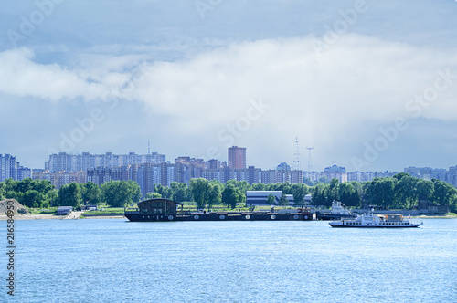 City landscape. Barge and boat on the river.