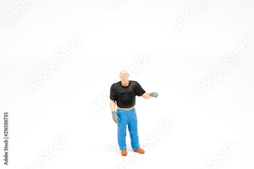 Miniature people cleaning up concept on background with a space for text