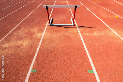 hurdle race barrier on red running track , athletic stadium