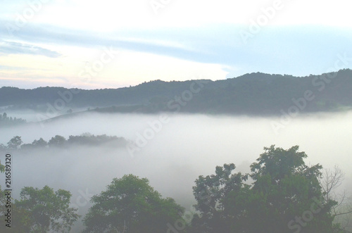 Amazing scenery of idyllic countryside with rolling hills veiled in morning fog. Aerial view of hill on a foggy spring morning 