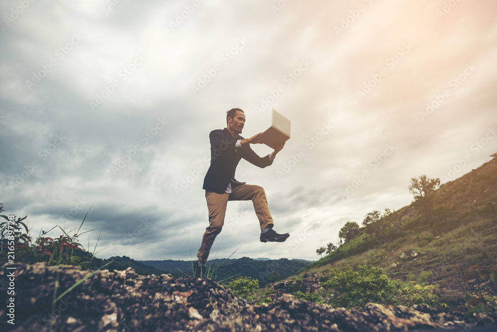 businessman jumping over the mountain, business worker concept