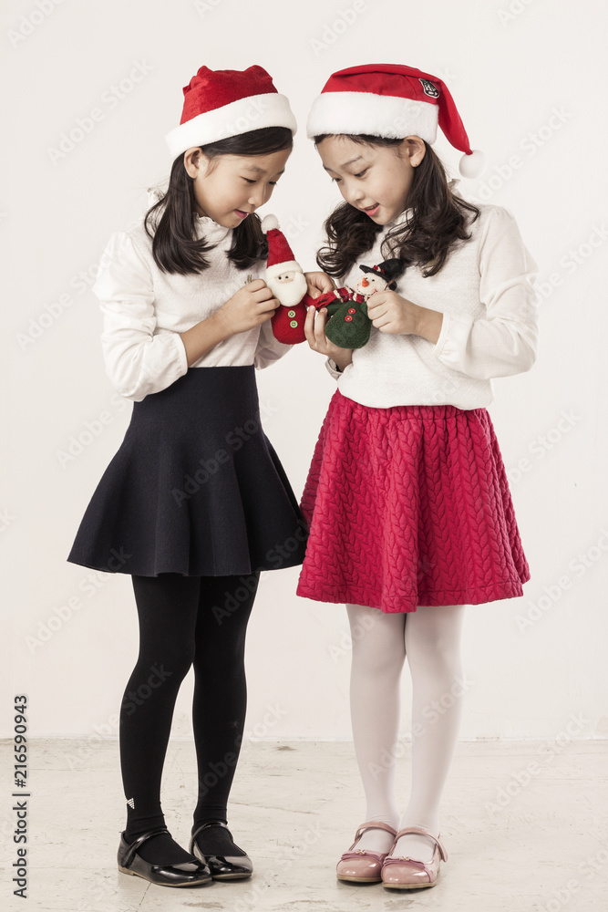 Obraz premium A asian girl portrait with christmas dolls isolated white.