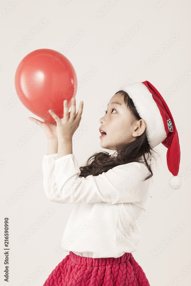 A asian girl portrait with christmas balloon isolated white. A asian girl portrait with christmas balloon isolated white.