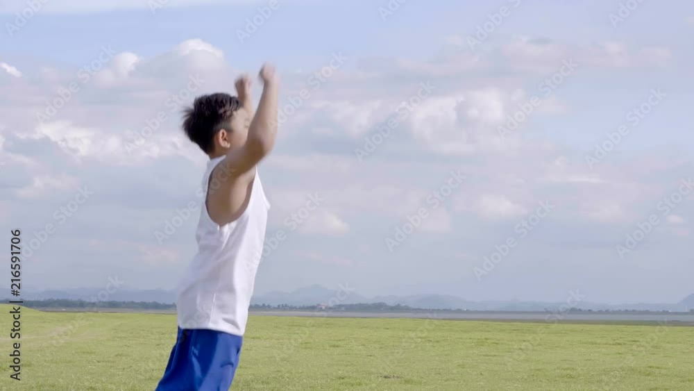Little boy two old 7 years Happy with a running and throwing paper airplane on meadow in summer in nature Sunset time. 4K Video Slow motion Little boy two old 7 years Happy with a running and throwing paper airplane on meadow in summer in nature Sunset time. 4K Video Slow motion