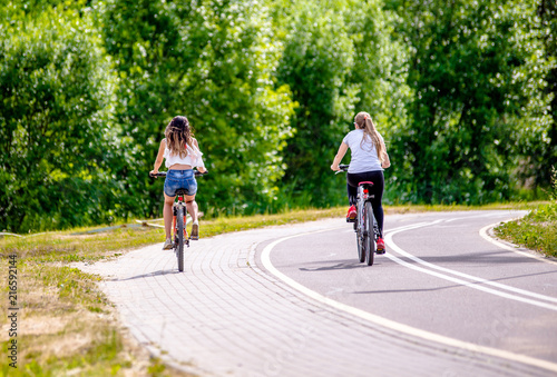 Wallpaper Mural Cyclists ride on the bike path in the city Park  Torontodigital.ca