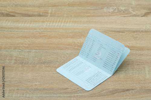 Passbook or account book, statement on wooden working table, savings and banking concept.