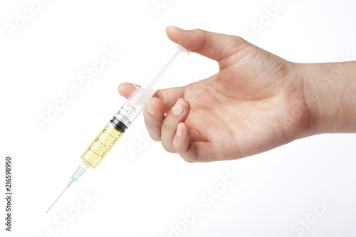 hand hold a yellow syringe isolated white.
