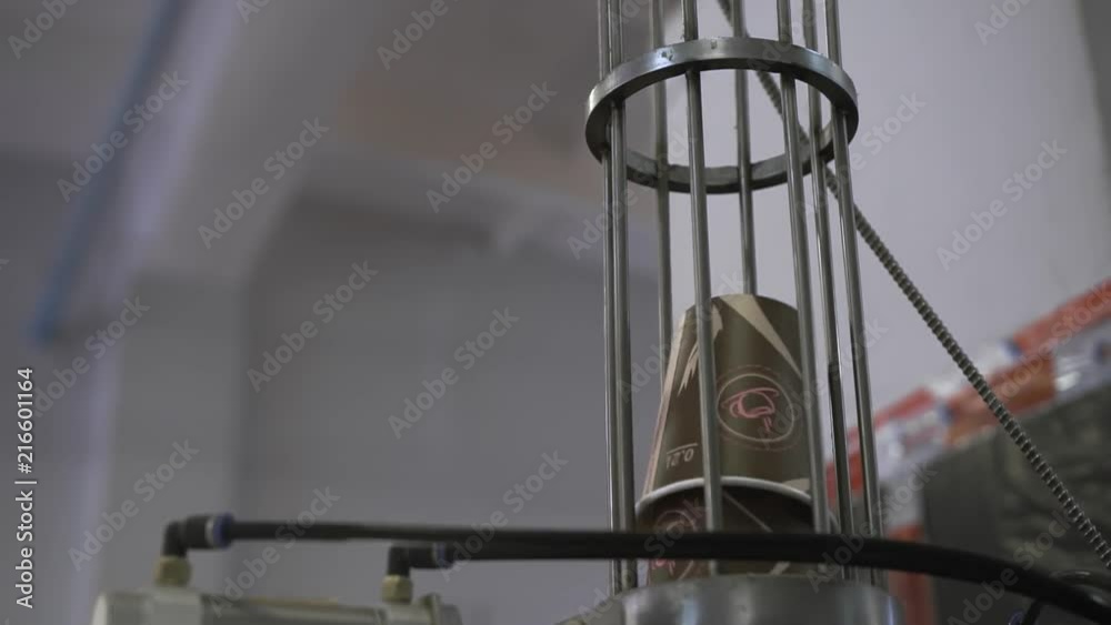 Paper cups are moved to packing area by pneumatic mail. Eco-friendly ...