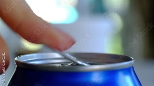 Close up of womans hand opening a can photo