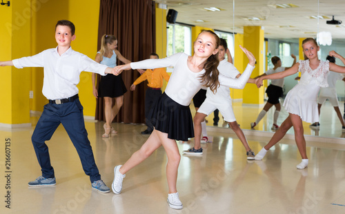 Positive children are dancing rock-n-roll in pairs