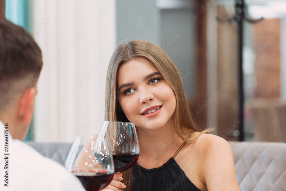 Beautiful young couple with glasses of red wine in luxury restaurant Beautiful young couple with glasses of red wine in luxury restaurant