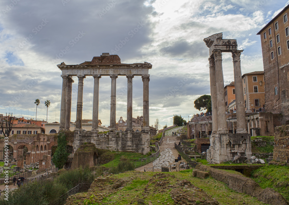 old columns gate in Roman Forum ruins, Rome city. Italy