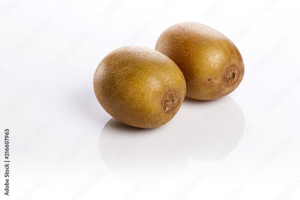 two golden kiwis on the white bottom. two golden kiwis on the white bottom.