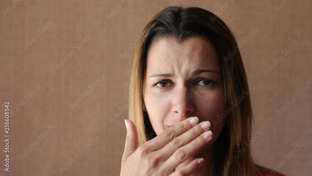 Beautiful young woman with sores from herpes on her lips. The girl is sick of laughing because of the cold on her lips. Grimace of pain. Beautiful young woman with sores from herpes on her lips. The girl is sick of laughing because of the cold on her lips. Grimace of pain.