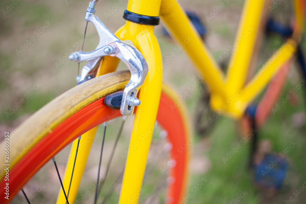 Front wheel of Yellow bicycle in the park Front wheel of Yellow bicycle in the park