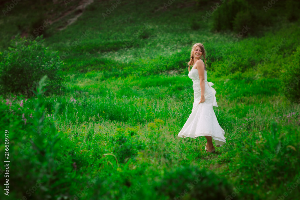 beautiful bride against the backdrop of the mountain and grass beautiful bride against the backdrop of the mountain and grass