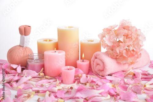 Many pink tropical petals and candle ,soap ,herbal ball,towel ,candle, salt in bowl 