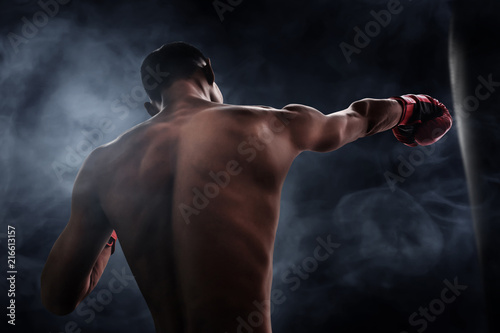 Boxer training with punching bag © fotokitas
