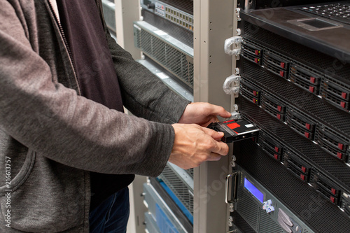 Changing hard drive in a server room.