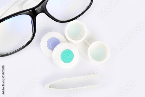 Contact lens  contact lens case  tweezers on white background. Correction of vision.